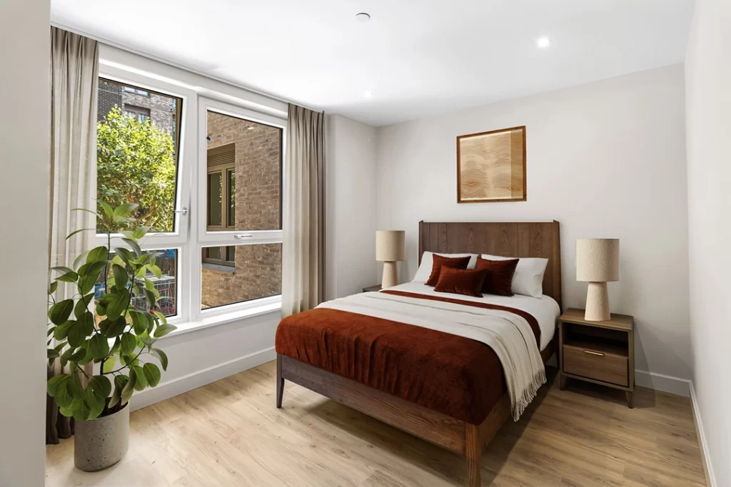 Furnished bedroom with large windows and lots of natural light