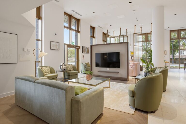 Communal TV lounge at The Wiltern with sofas, armchairs and floor-to-ceiling windows