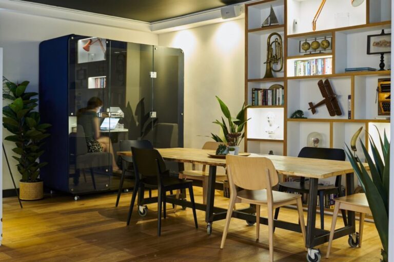 Coworking area at UNCLE Stockwell with private work pod and communal table