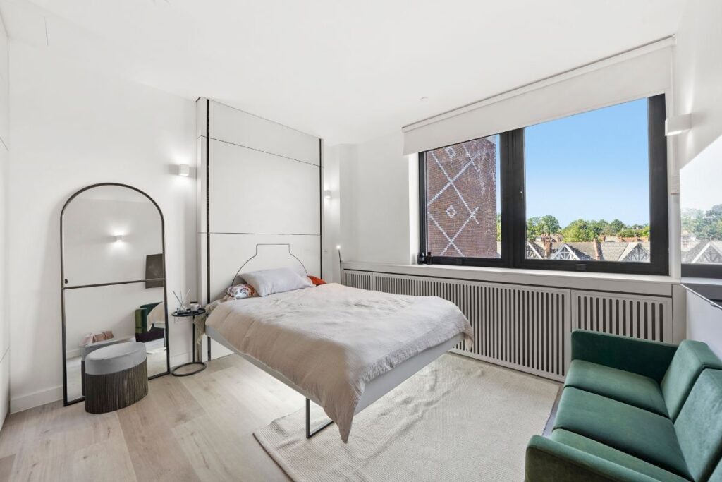 Studio apartment with floating bed system and large window overlooking Harrow