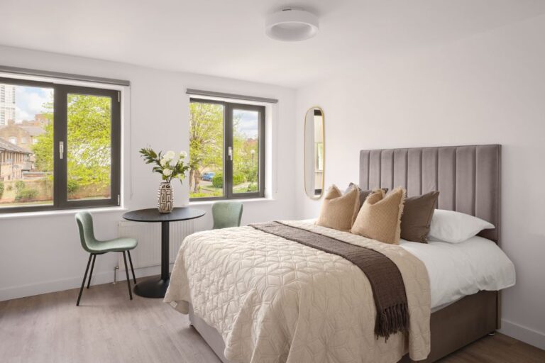 Bright bedroom at Kendon House apartment in Stratford with large windows and contemporary finishes