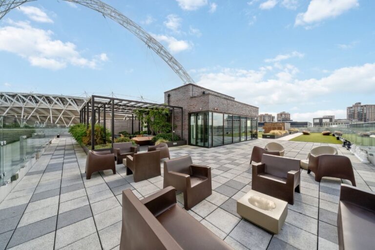 Rooftop terrace seating area with Wembley Stadium arch visible in the background