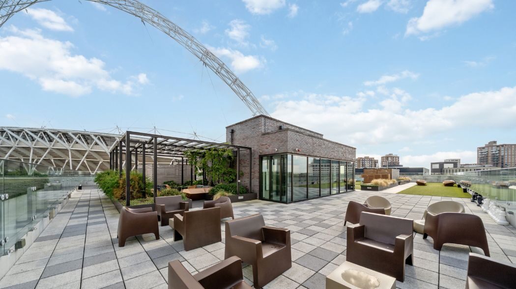 Rooftop terrace seating area with Wembley Stadium arch visible in the background
