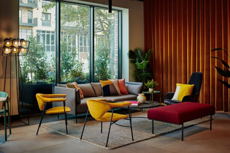 Residents lounge at UNCLE Southall with modern seating and floor to ceiling windows