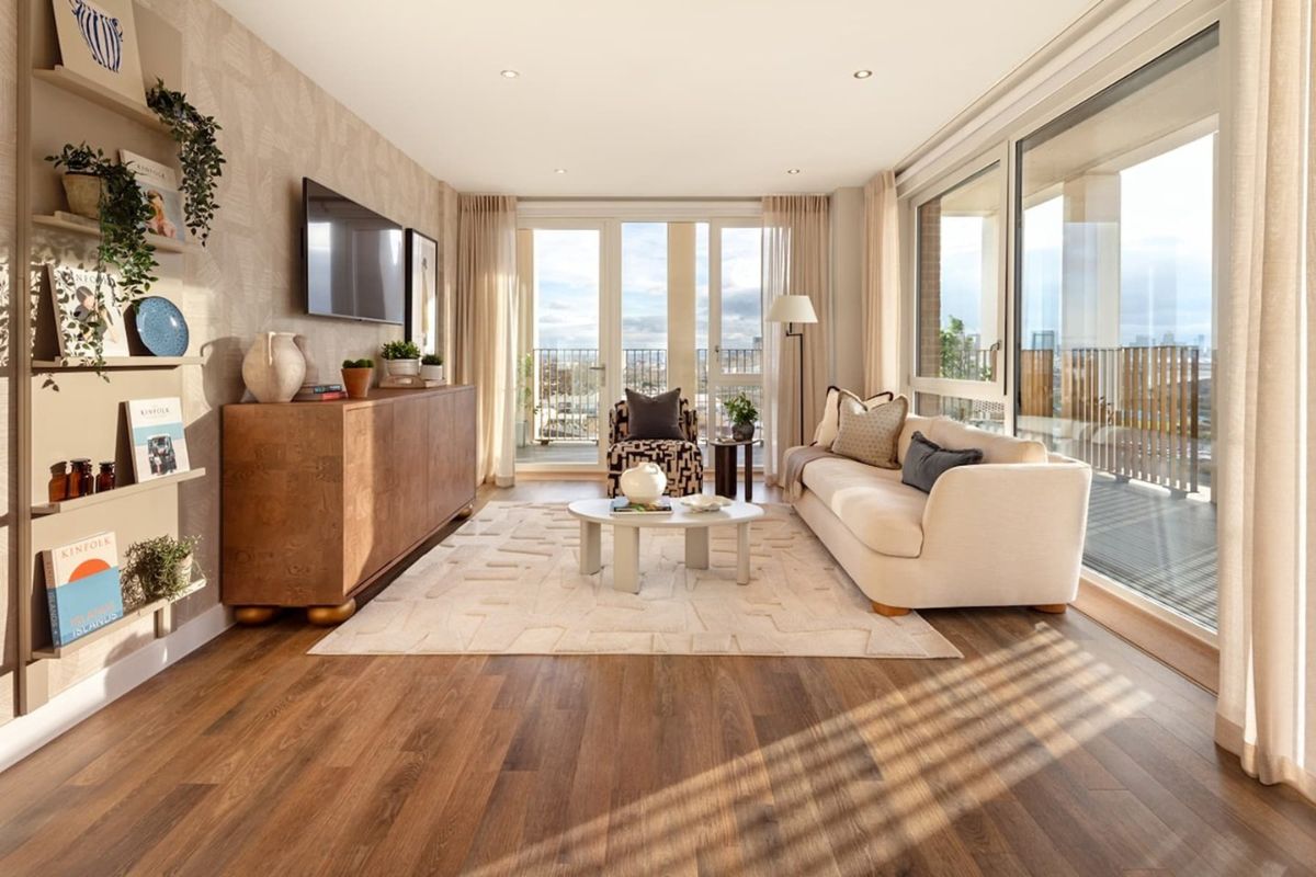 Bright open plan living room with floor to ceiling windows and private balcony