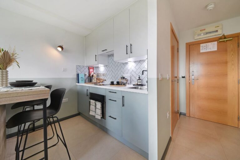 Kitchen area inside UNCLE Stockwell studio apartment with integrated appliances