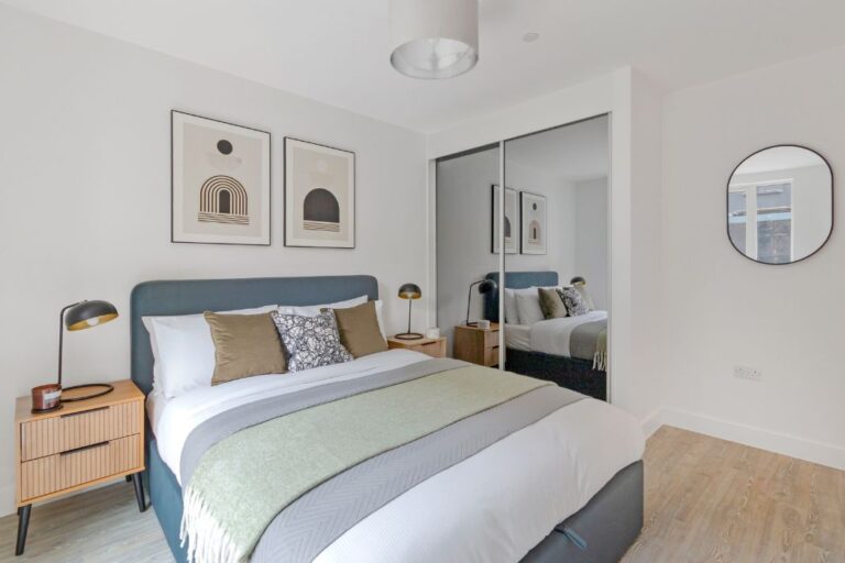 Double bedroom at Lampton Parkside with fitted mirrored wardrobes and natural light
