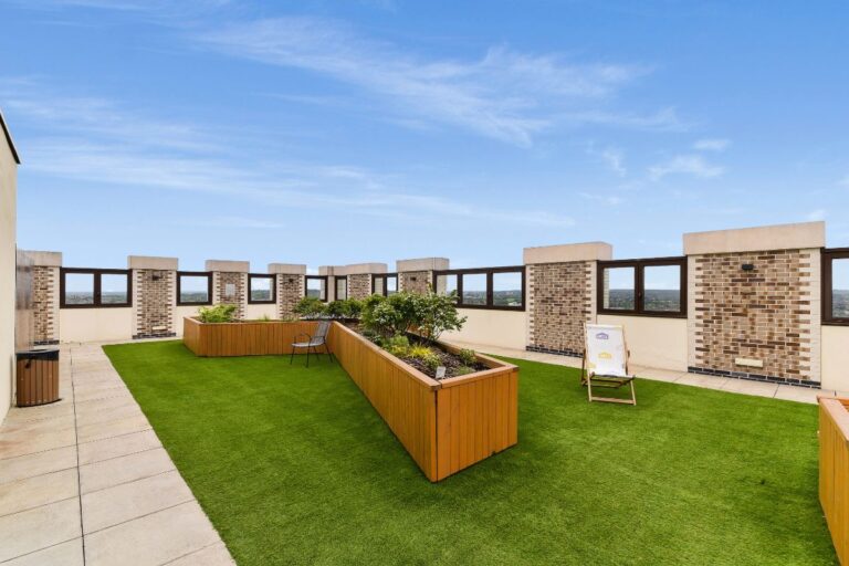 Rooftop terrace at UNCLE Wembley with landscaped planters and open skyline views
