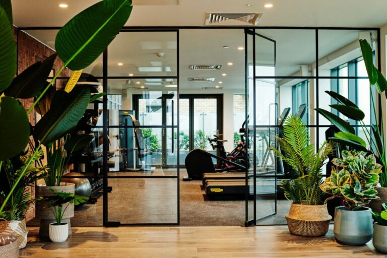 On site gym at UNCLE Southall apartments with cardio equipment and free weights