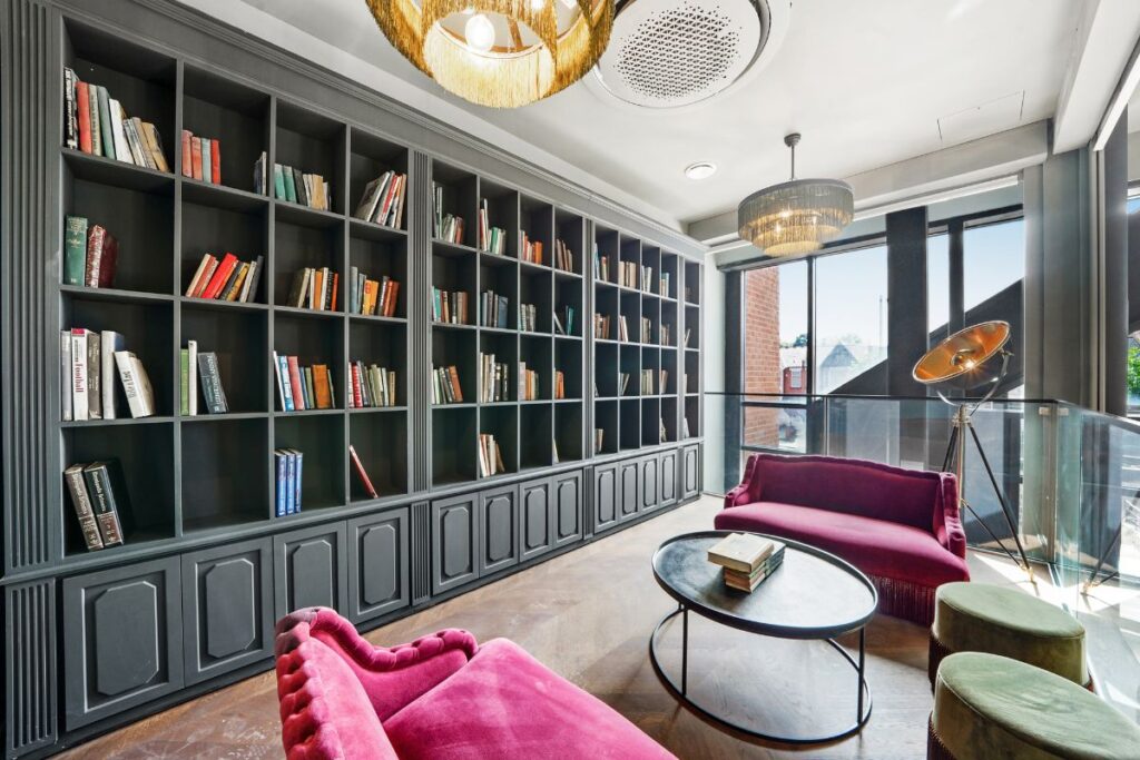 Residents library with floor to ceiling shelving and lounge seating
