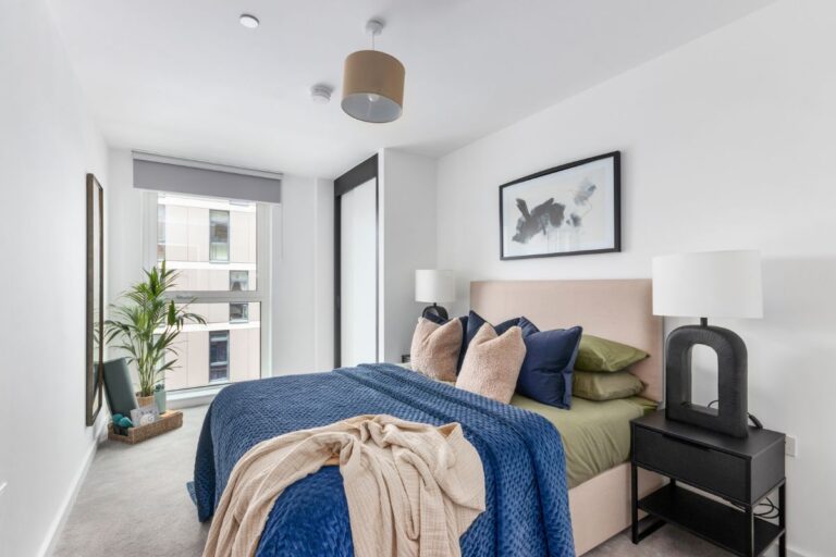 Double bedroom with upholstered bed, bedside tables and large window