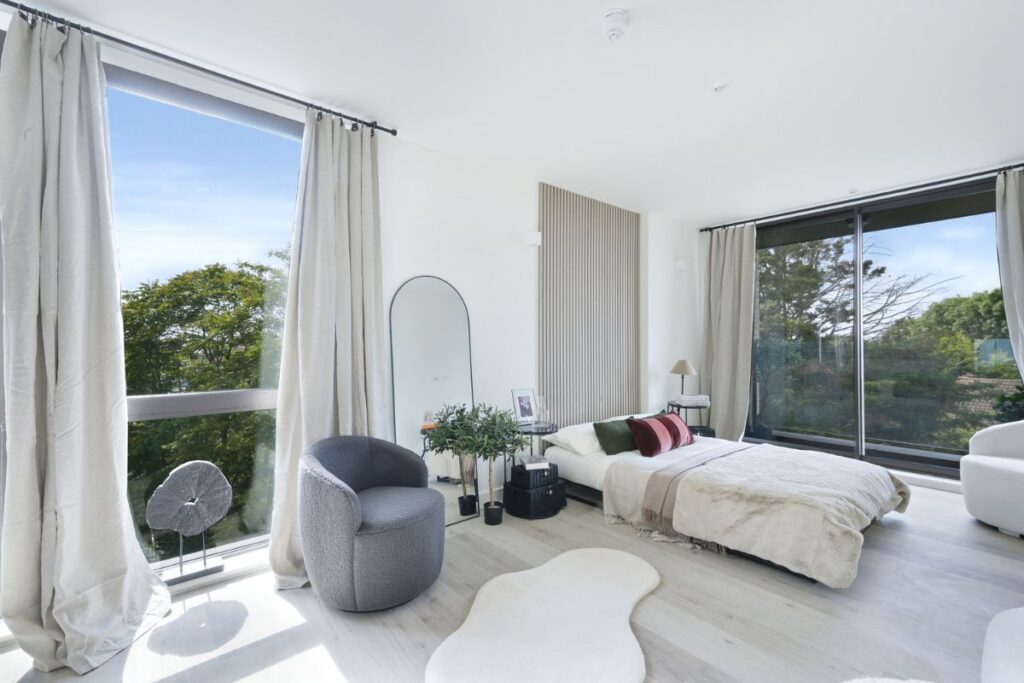 Spacious studio apartment with seating area and balcony access