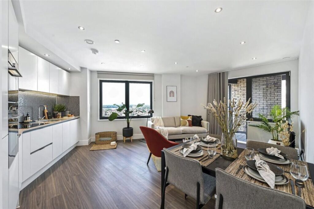 Open plan kitchen and living area inside UNCLE Southall apartment with balcony access
