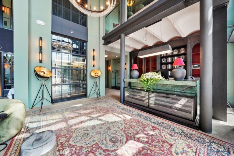 Double height reception area with concierge desk and contemporary lighting