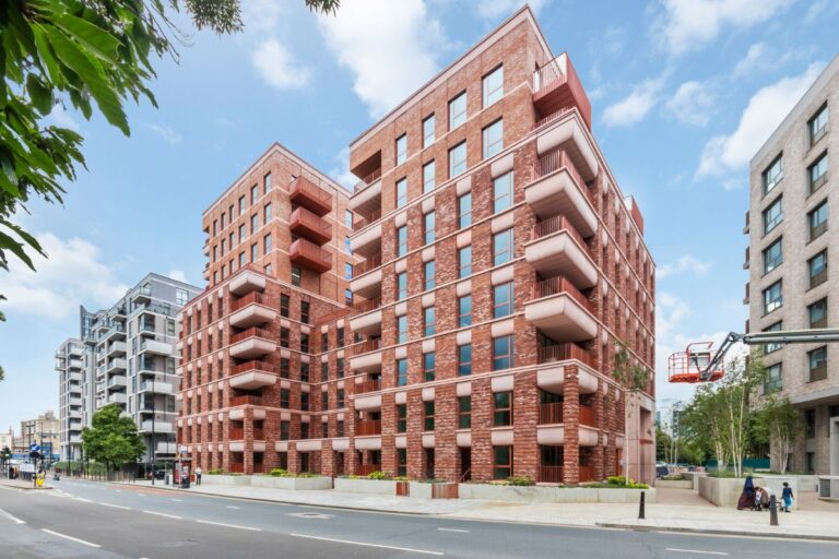 Modern brick apartment building with balconies on Escapade Place in Blackwall Reach