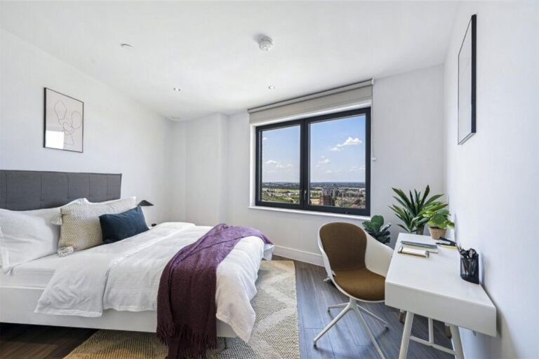 Bedroom at UNCLE Southall apartment with large window and natural light