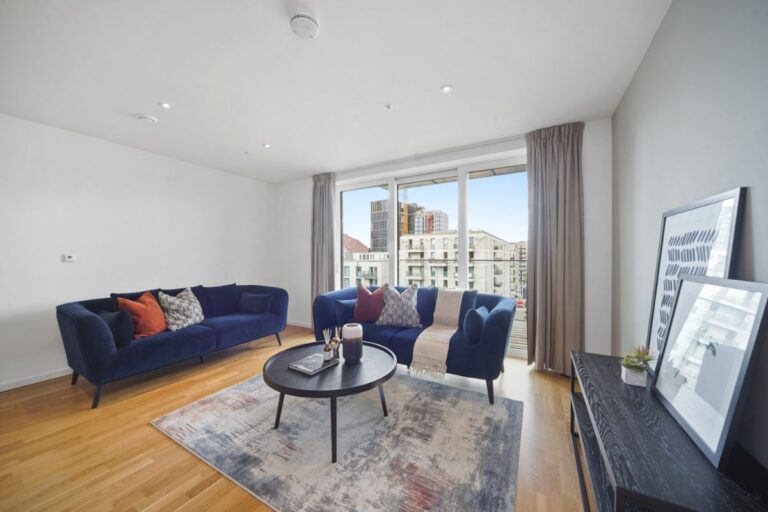 East village apartment living room with floor to ceiling windows.
