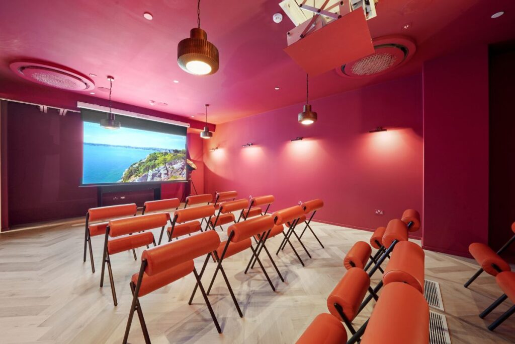 Private cinema room with tiered seating and large projection screen