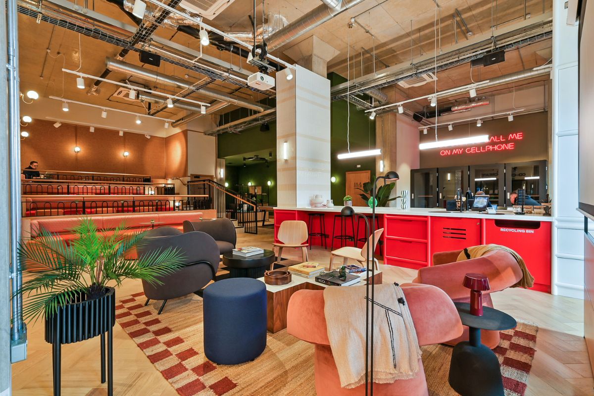 Coworking and social space at UNCLE Wembley with reception desk and communal seating