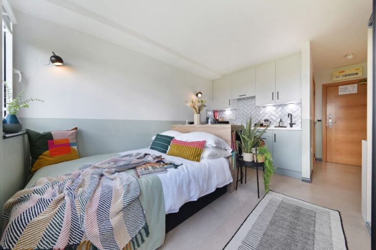 Open plan studio apartment at UNCLE Stockwell with kitchen and sleeping area