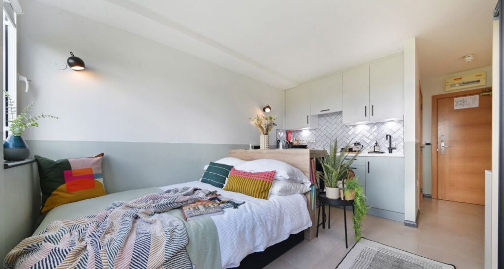 Open plan studio apartment at UNCLE Stockwell with kitchen and sleeping area