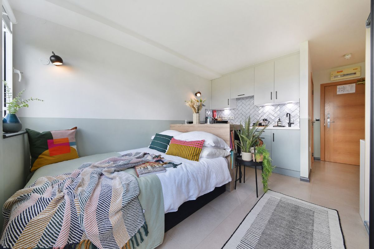 Open plan studio apartment at UNCLE Stockwell with kitchen and sleeping area