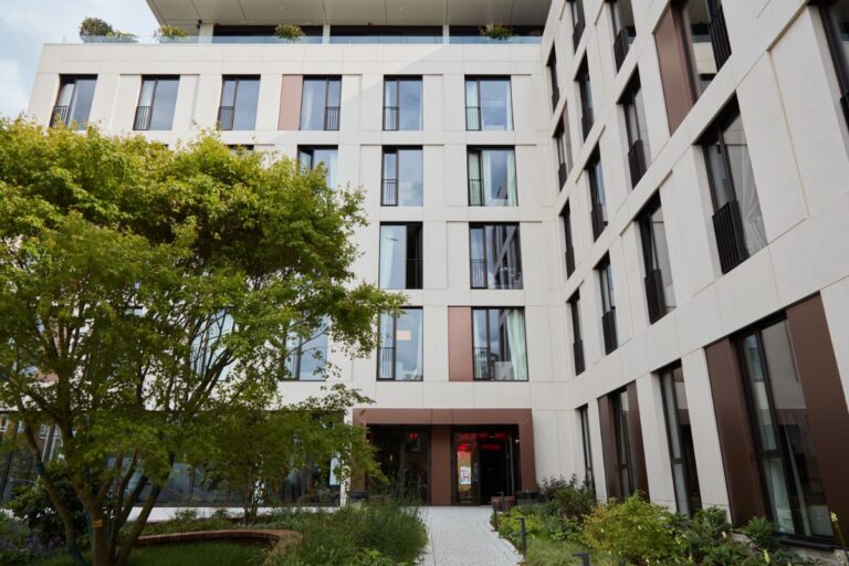 Exterior courtyard at Dandi Battersea showing the building facade and landscaped space