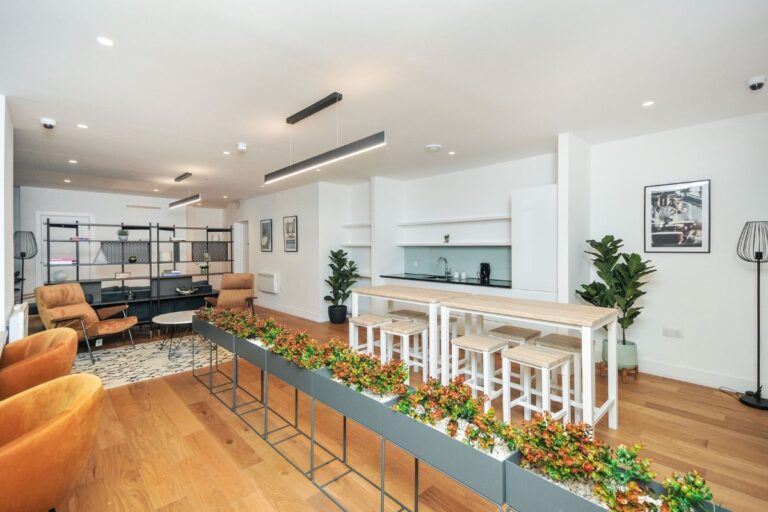 Residents’ lounge at The Residences Croydon with seating and shared workspace area