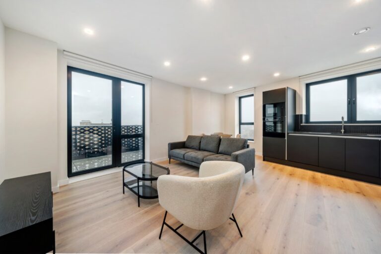 Living area at Hanwell Square apartment with balcony access
