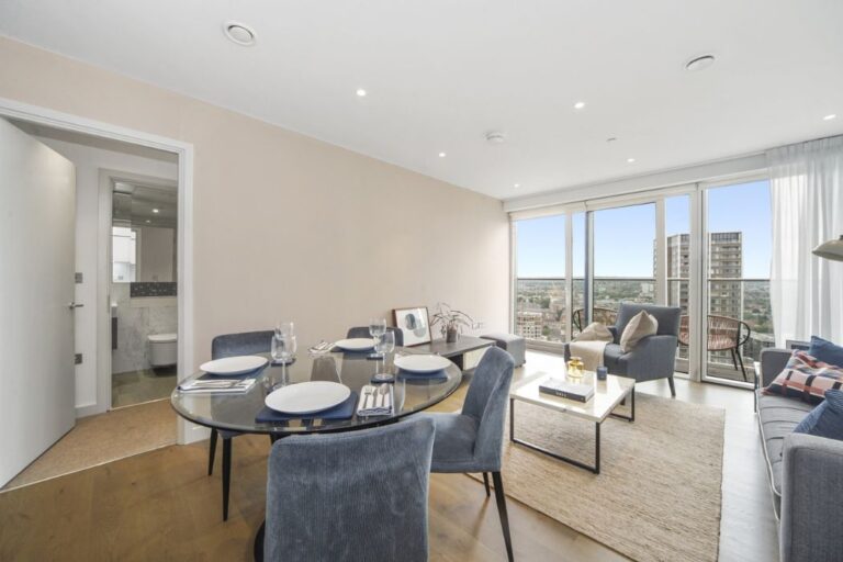 Open plan living and dining area with balcony access and natural light