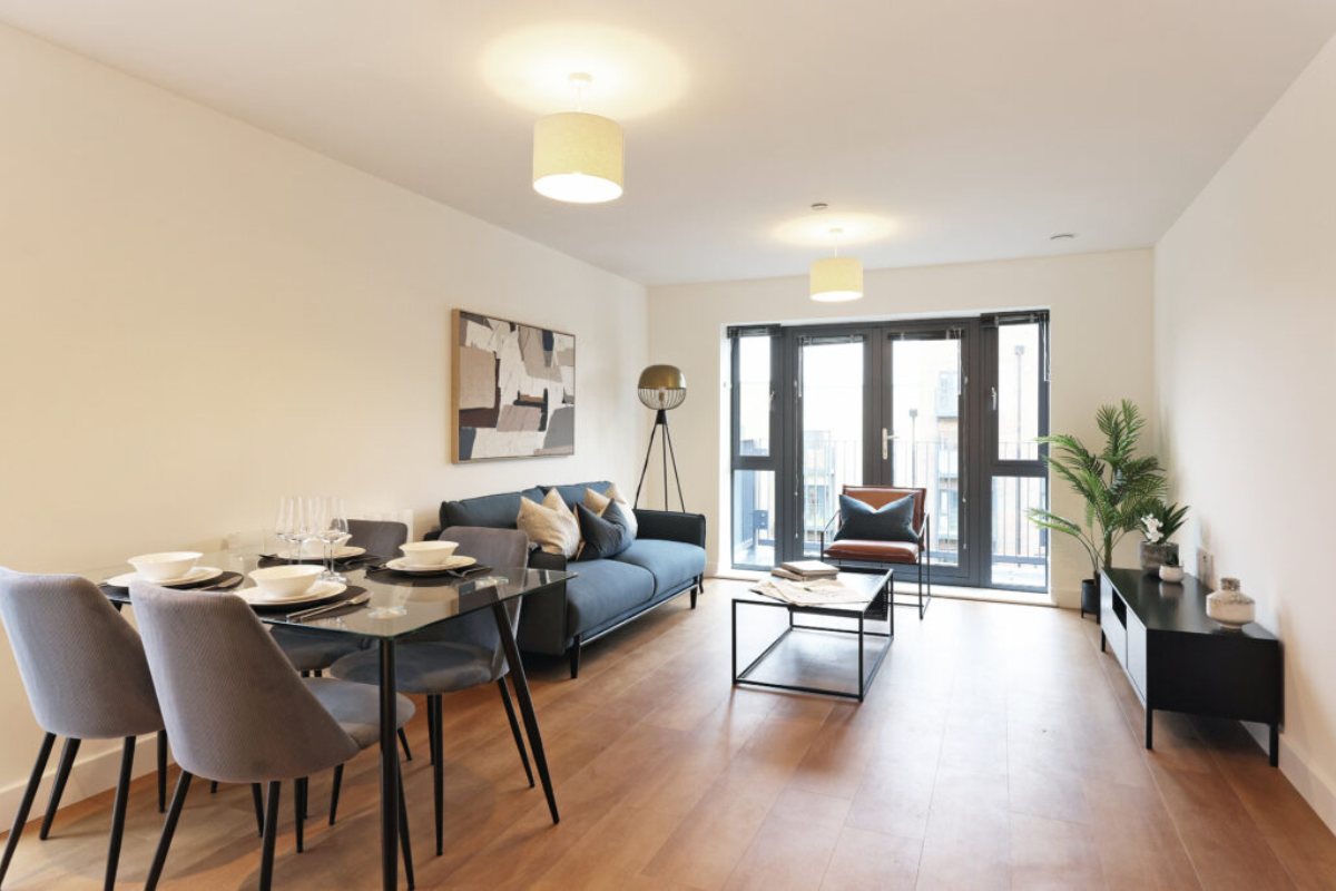 Living room inside The Cavalry Arborfield apartment with balcony access