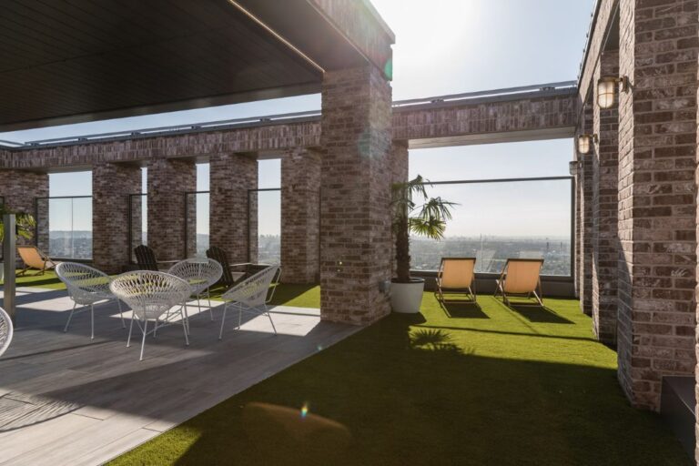 Roof terrace at Canada Gardens, with tables, chairs and sun loungers