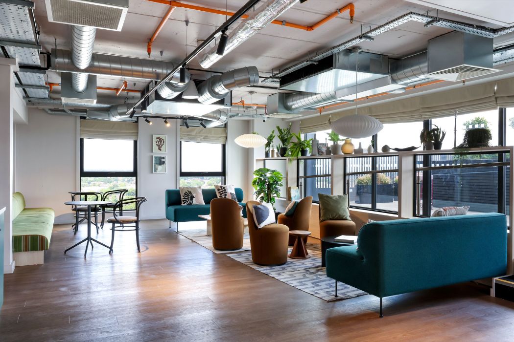 Resident lounge with seating and large windows at Sienna House