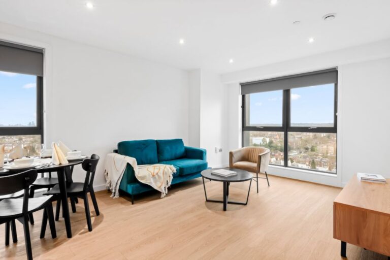 Resident lounge with seating and large windows at Sienna House