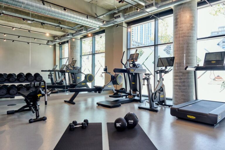 Residents gym at Windlass Apartments with cardio equipment and weights