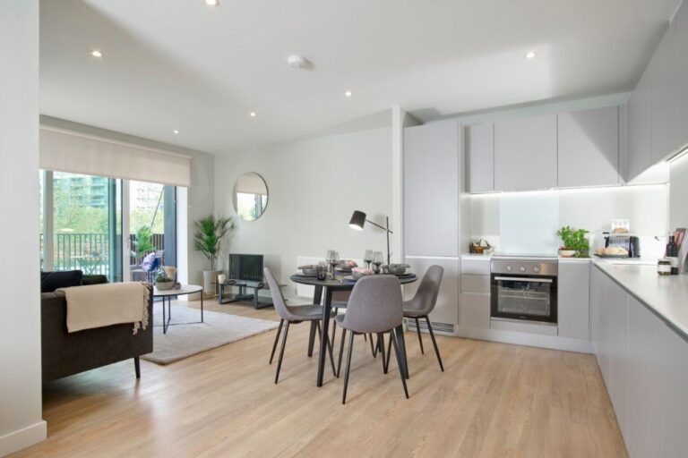 Open plan kitchen and living area at Windlass Apartments with modern finishes and dining space