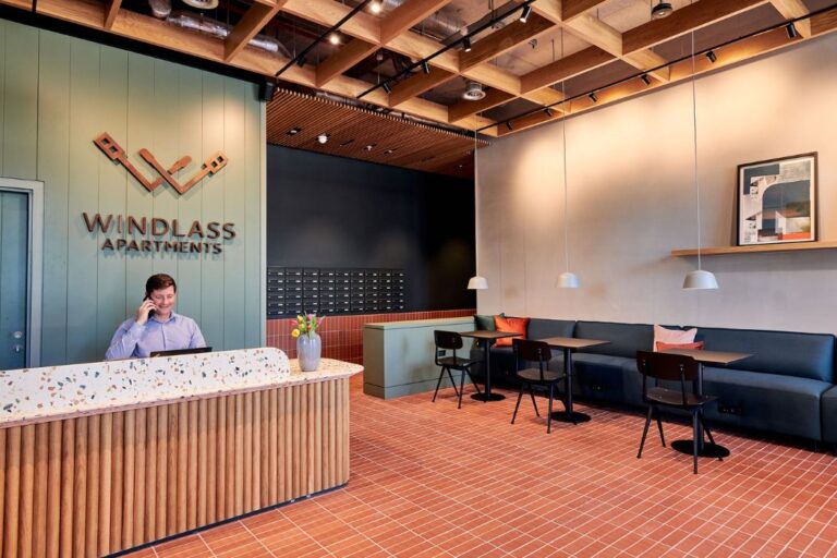 Reception and concierge area at Windlass Apartments with seating and resident services desk