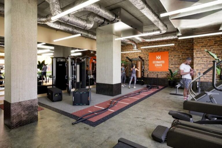 Gym with cardio machines, weights and industrial-style interior