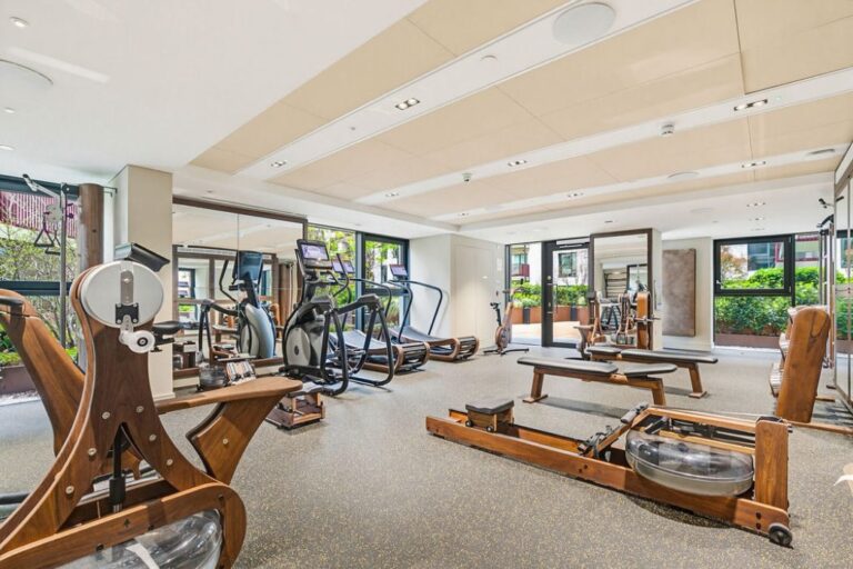 Fully equipped gym with cardio machines, weights and direct access to outdoor area
