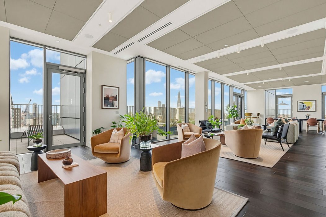 Residents lounge with floor to ceiling windows, seating areas and views across London skyline