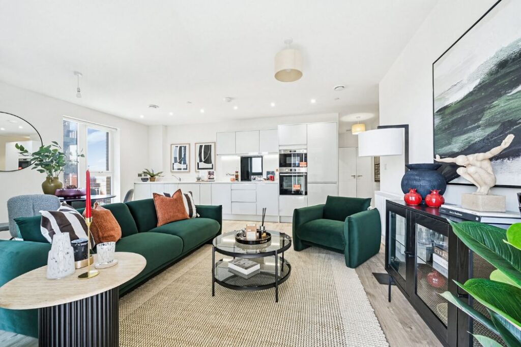 Modern kitchen and lounge area with balcony and floor-to-ceiling windows