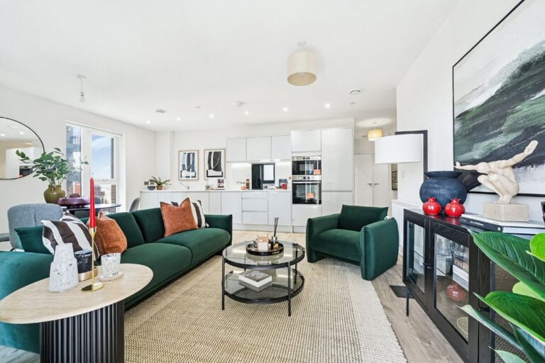 Modern kitchen and lounge area with balcony and floor-to-ceiling windows
