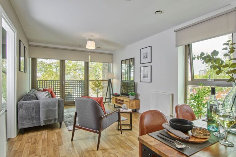 Apex Gardens living room with balcony and natural light