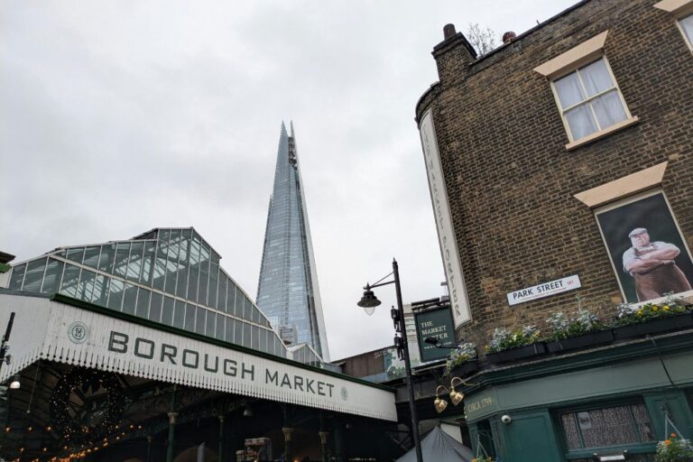 Borough Market sign with surrounding street and top of the Shard in the background