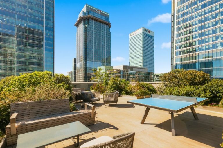 Rooftop terrace at 8 Water Street with table tennis, seating areas and Canary Wharf skyline views