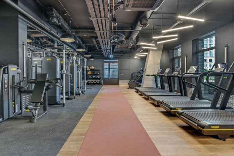 Residents gym at 50-60 Charter Street featuring Technogym treadmills, cable machines and cardio equipment