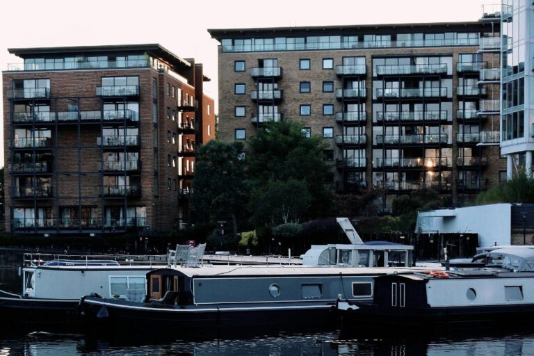 Narrowboats in front of contemporary apartments in Rotherhithe London