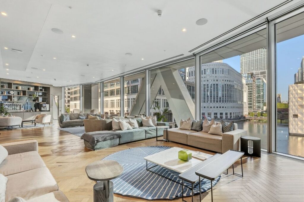 Residents lounge at Newfoundland in Canary Wharf with seating, self service bar and city views