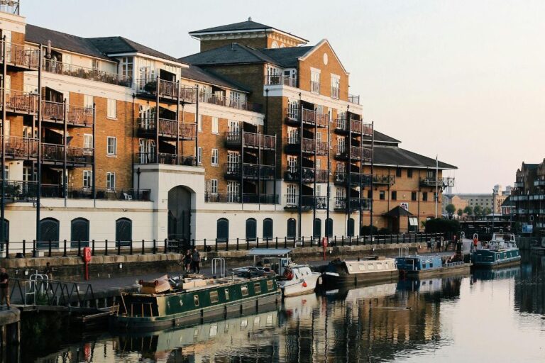 Canal boats docked in front of modern apartment development in Rotherhithe