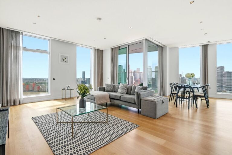Spacious living room at Arora Tower with panoramic skyline and river views